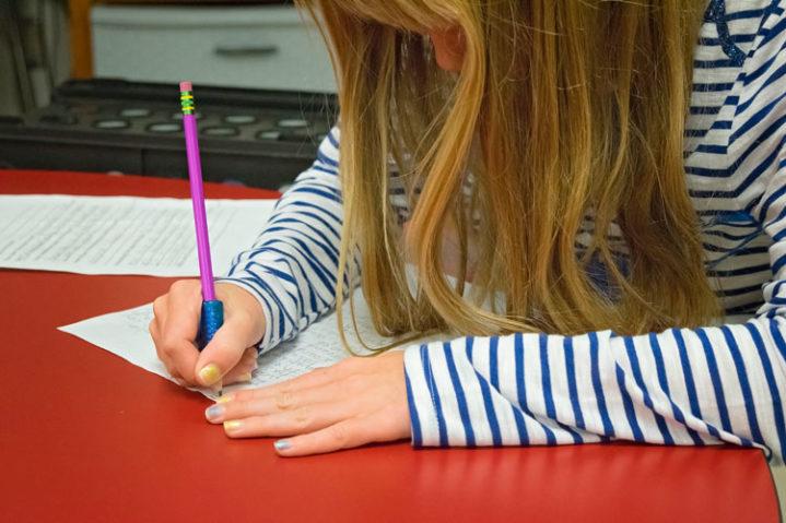 Lakeview Elementary Female student Writing on lined paper