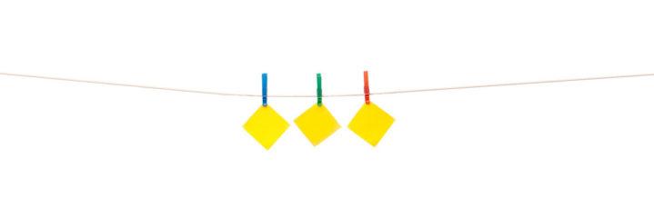 yellow notepaper hanging on clothesline