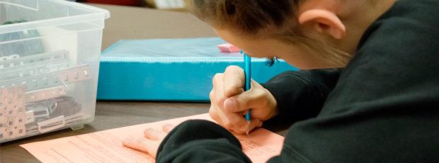 Howar Writing Girl on colored paper in shop class